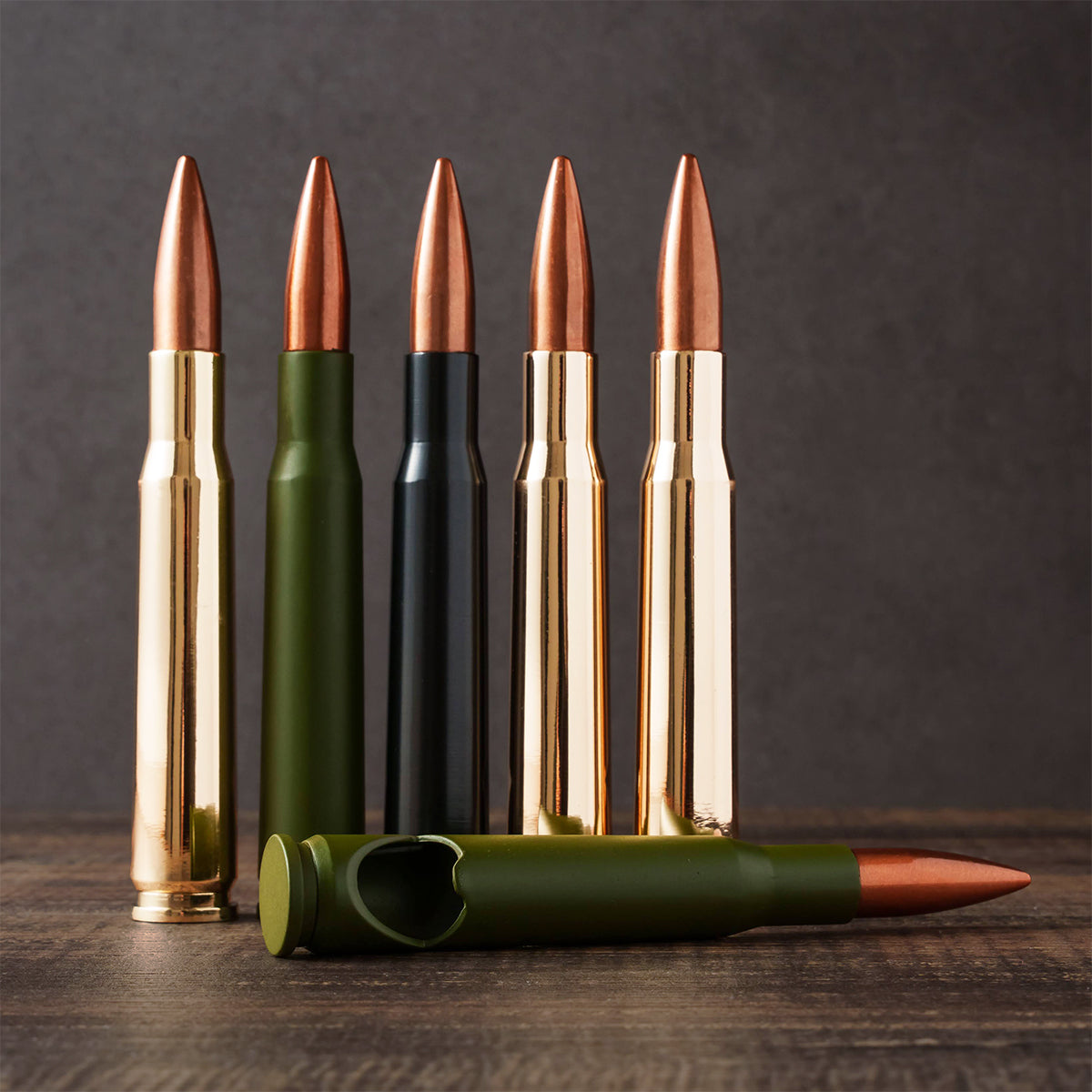 50-caliber bullet bottle openers in gold, green and black standing in a row