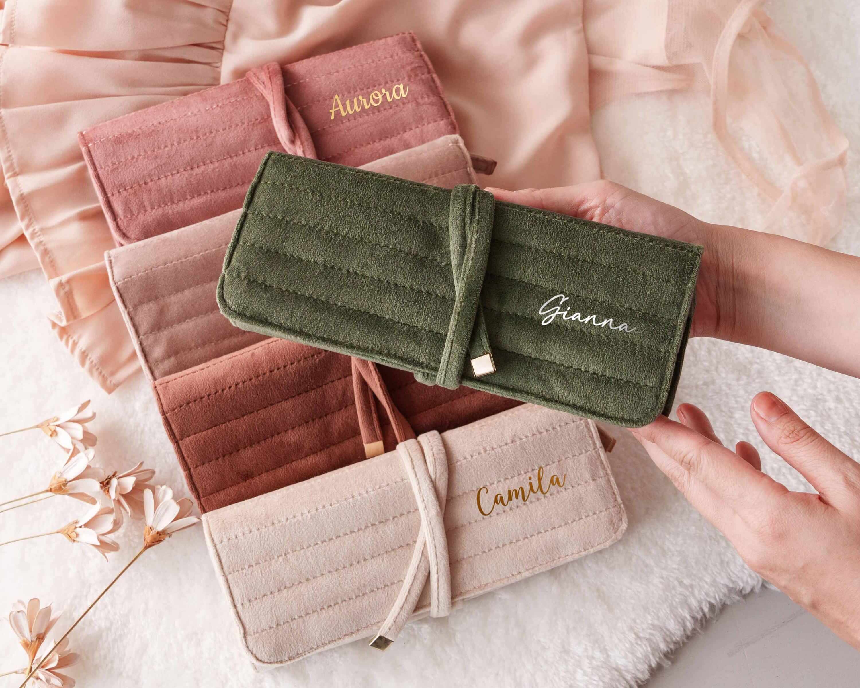 a woman's hand holding a wallet with a name on it