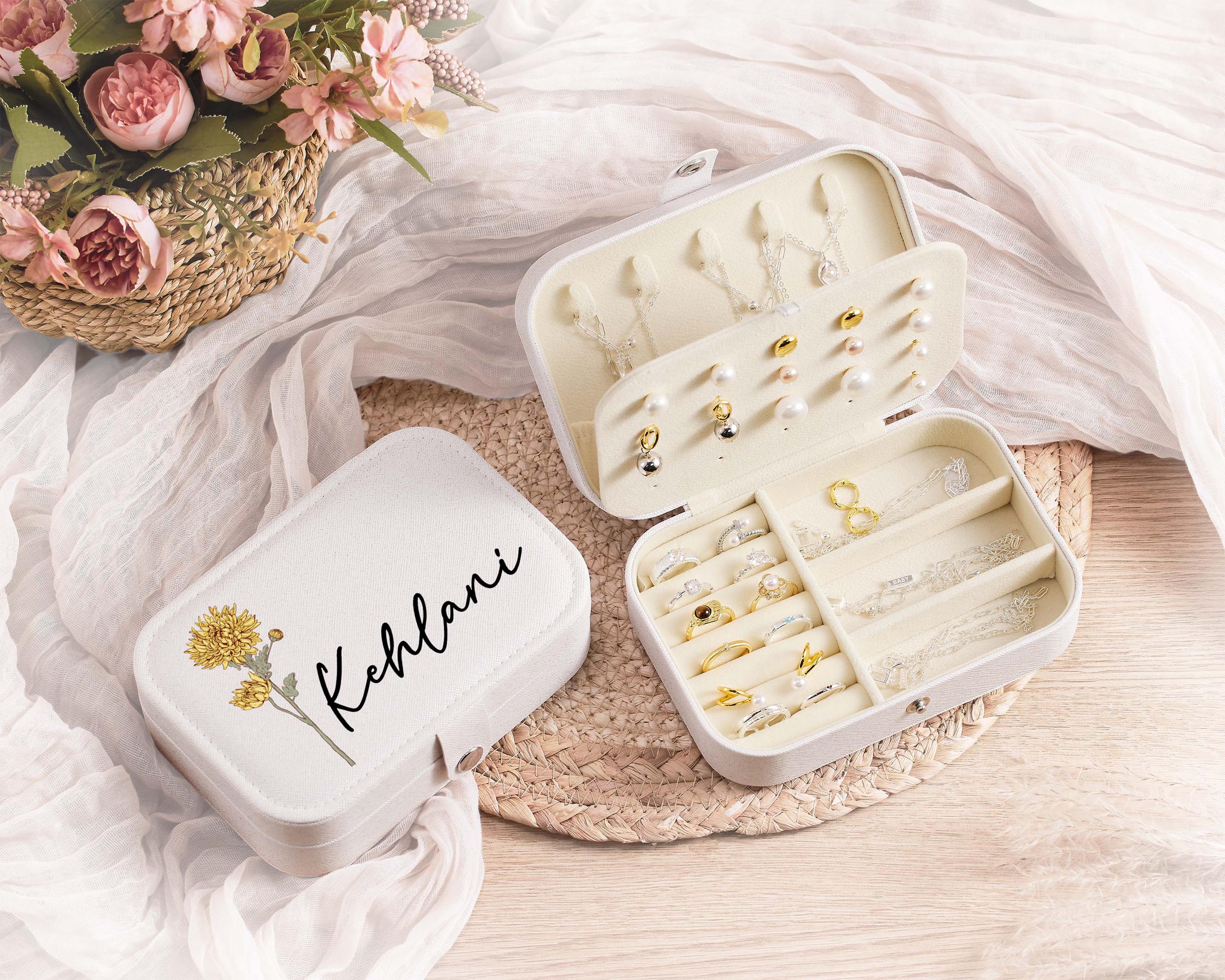 a white box filled with lots of jewelry sitting on top of a table