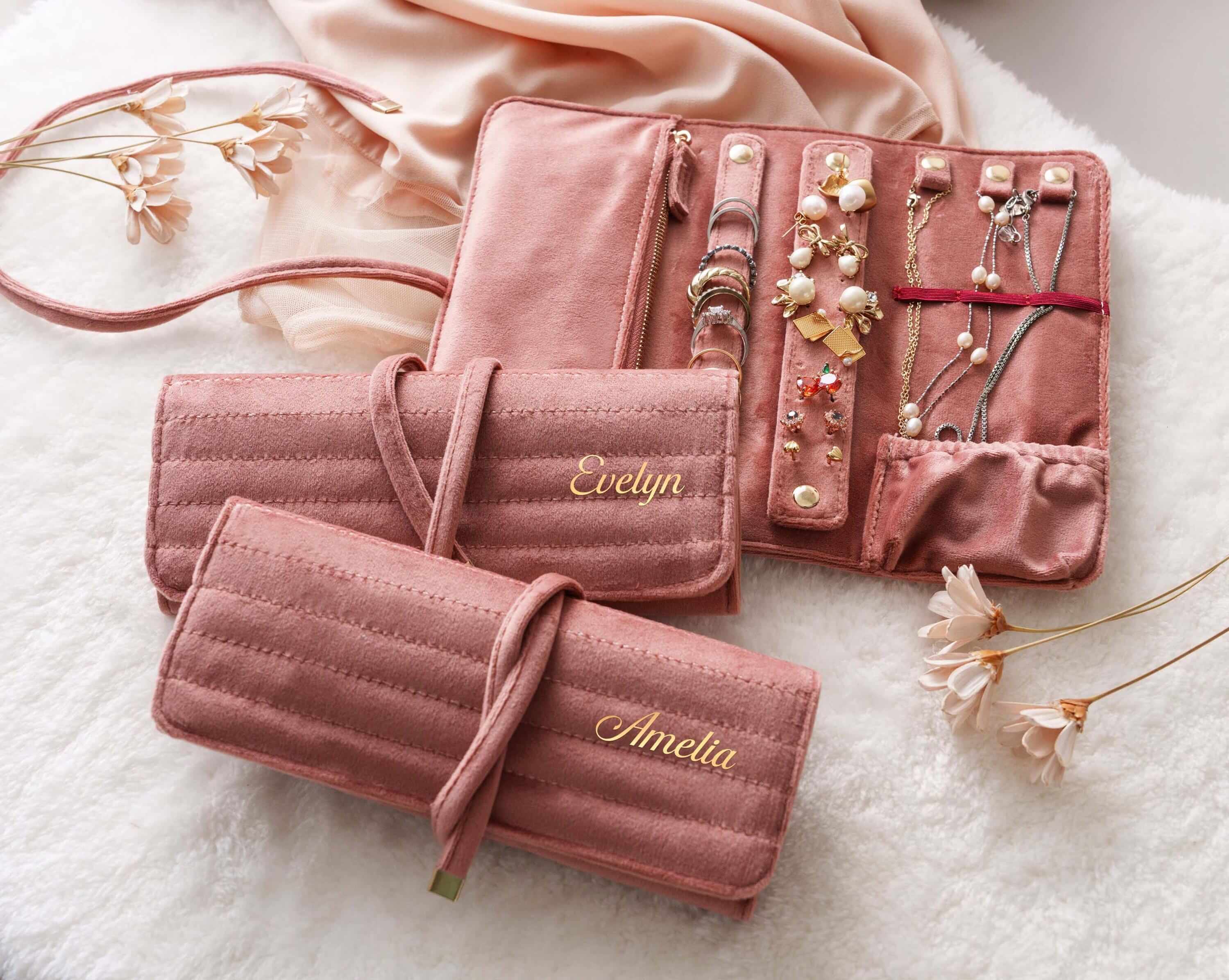 a set of three pink jewelry cases sitting on top of a white rug