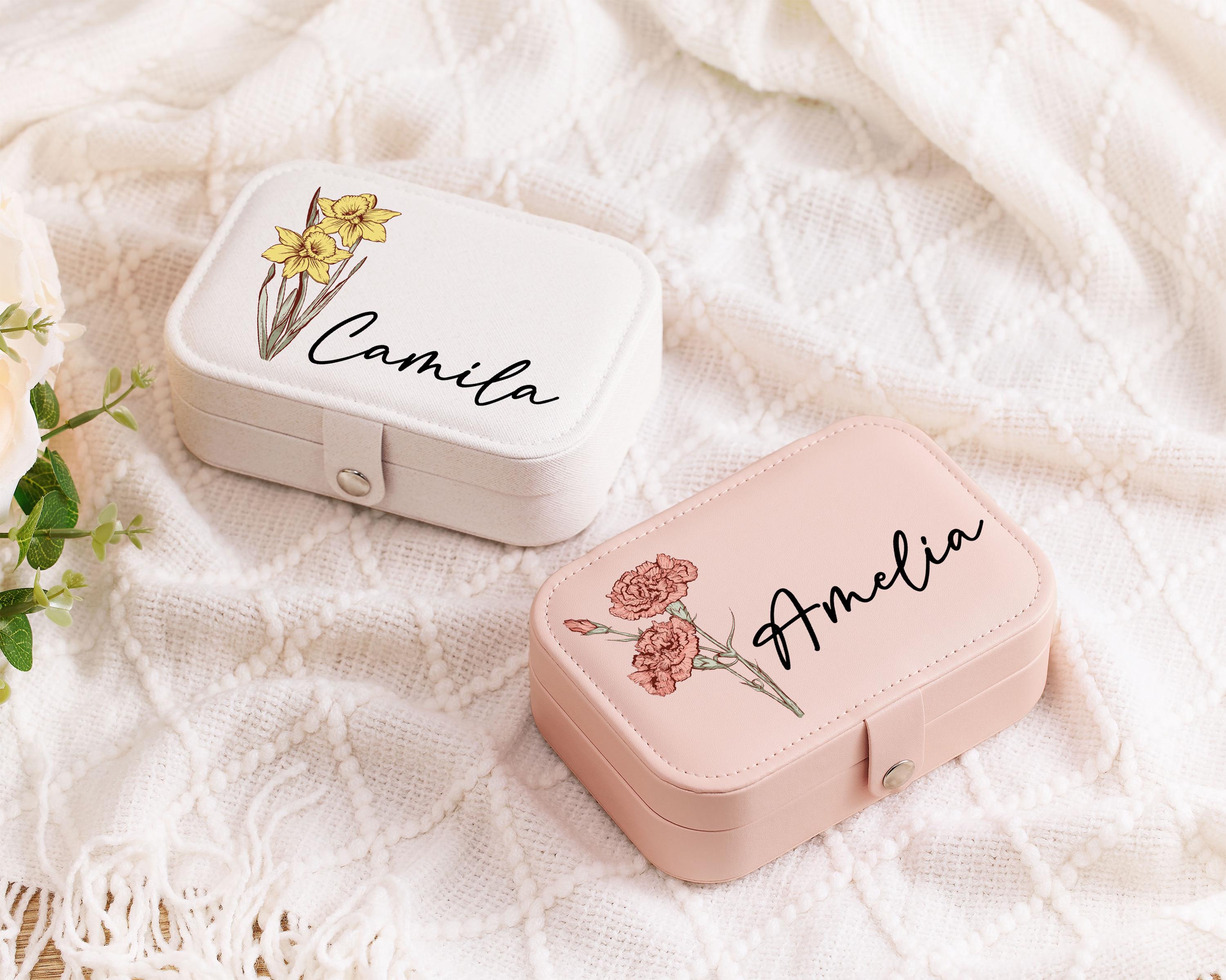 a pink and a white box with a name on it