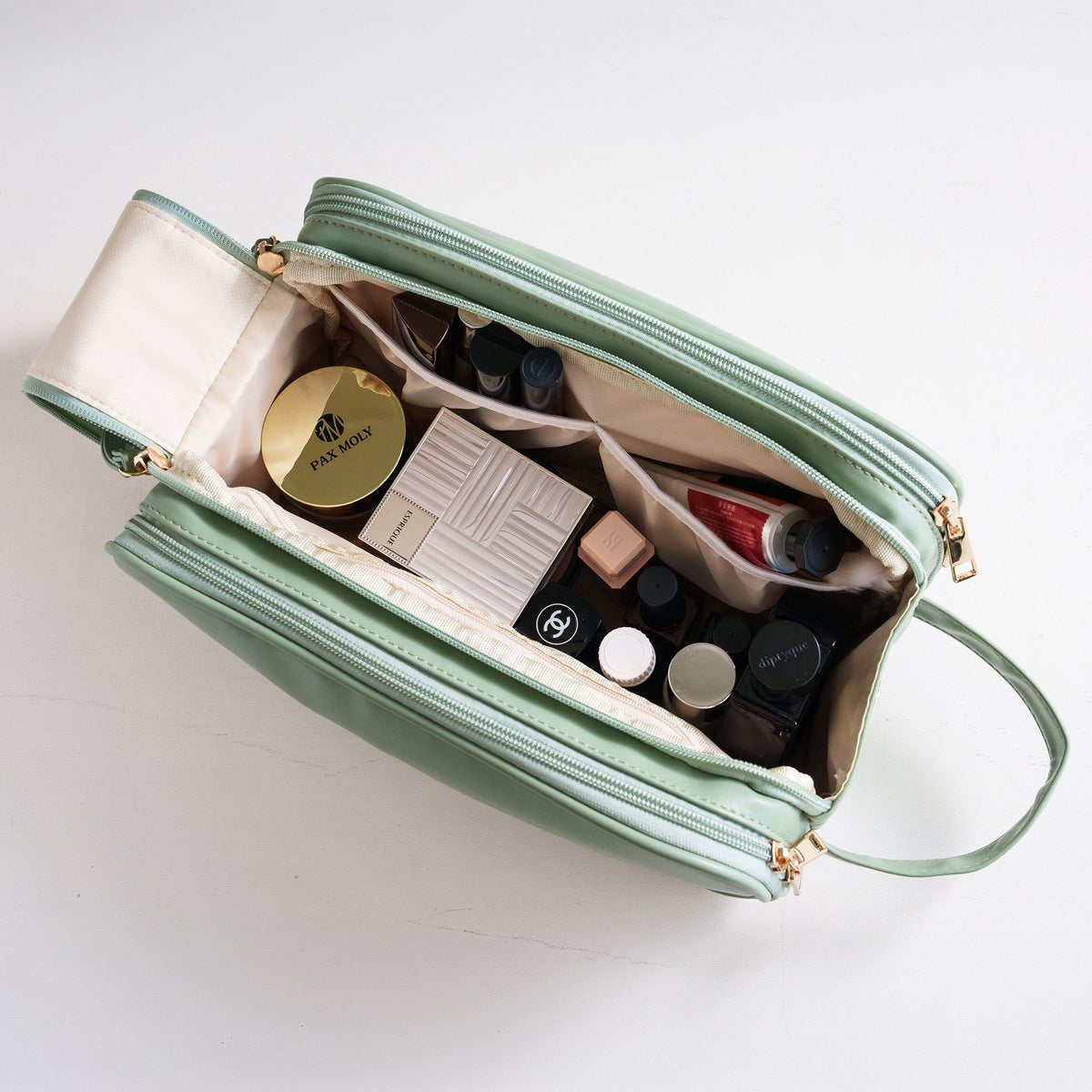 Top view of the open cosmetic bag packed with makeup and skincare