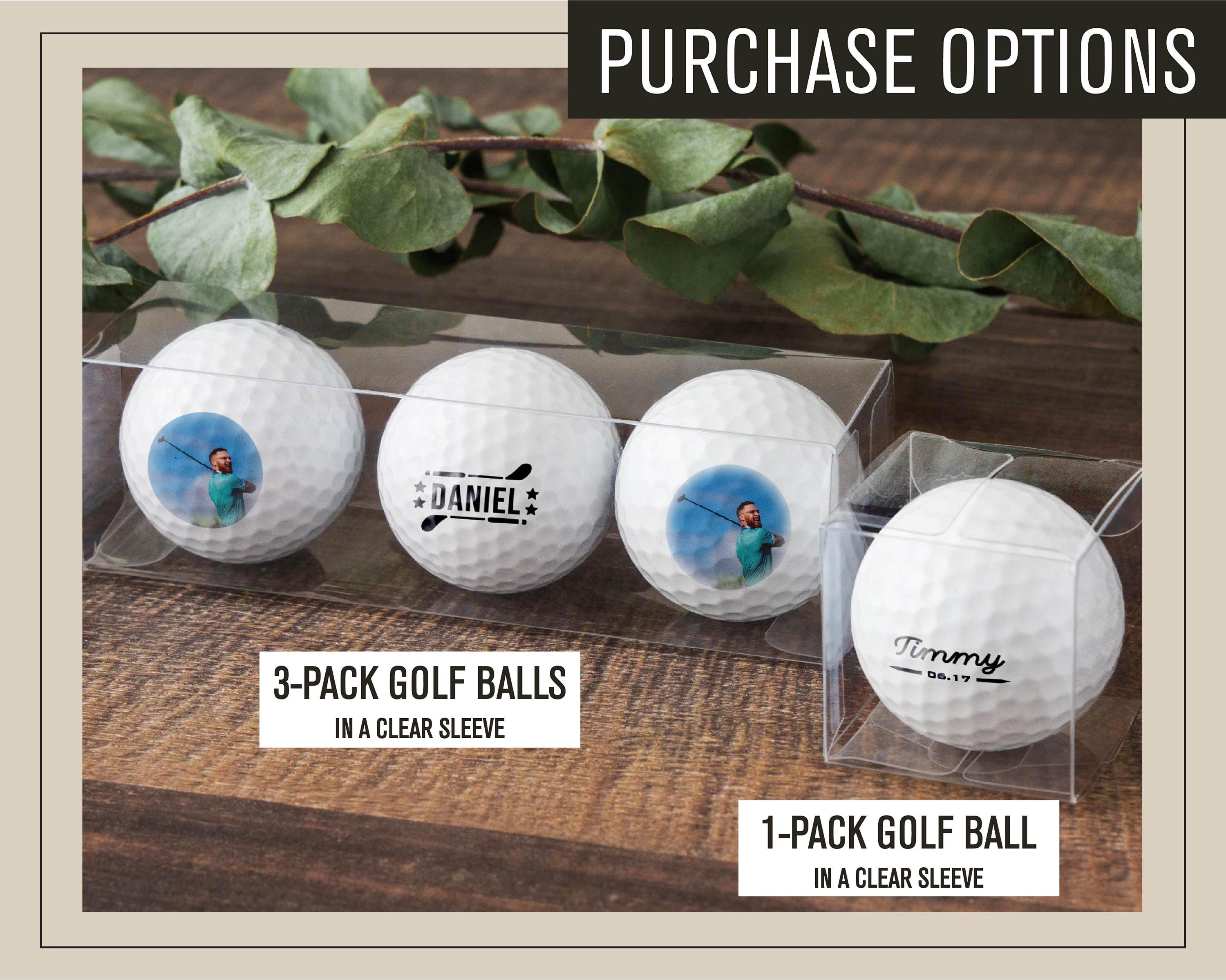 three golf balls in a clear display case
