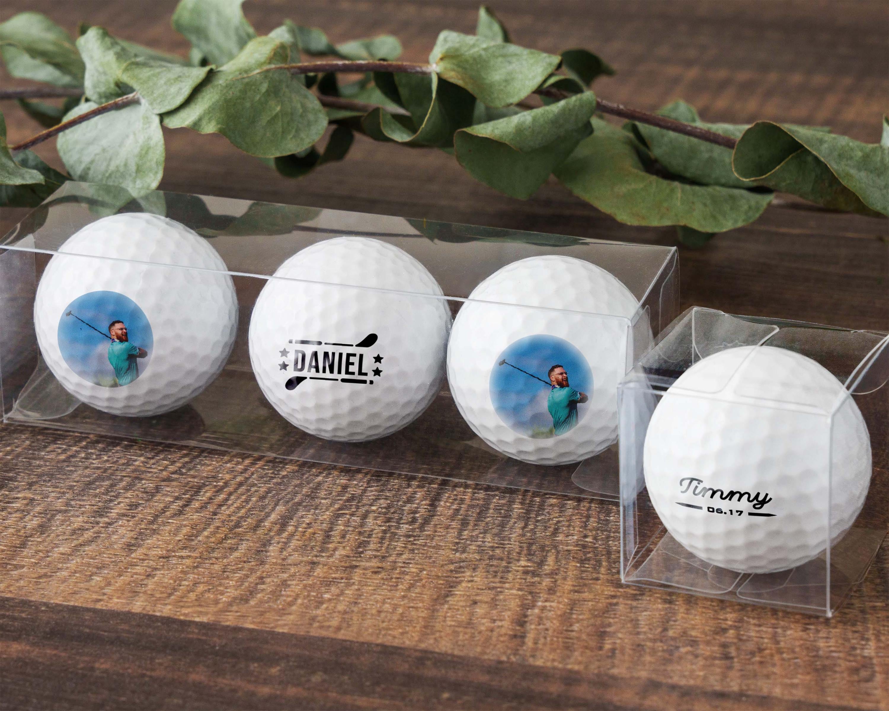 four white golf balls in a clear case