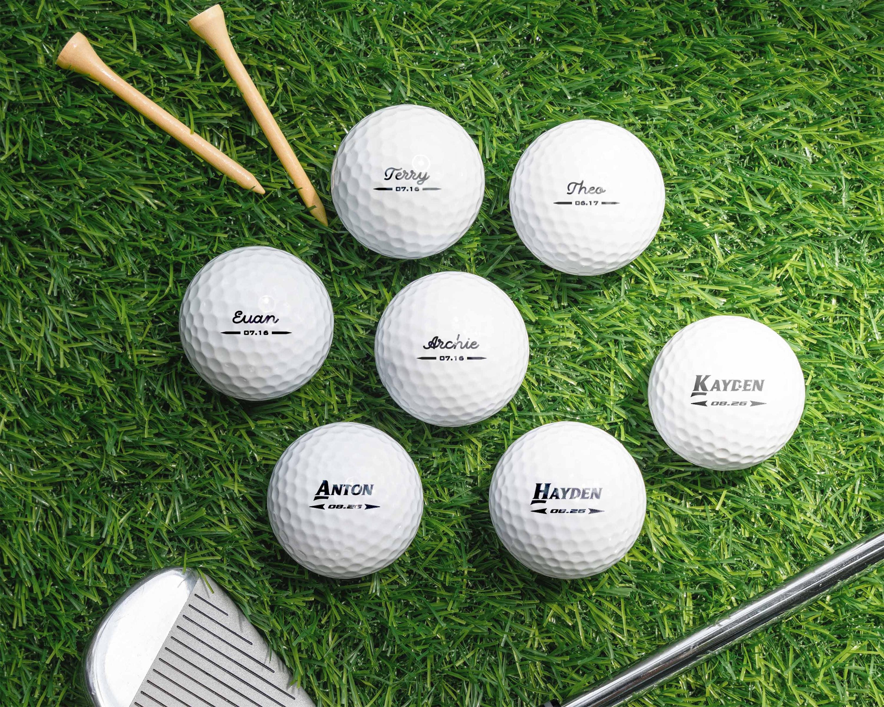 a group of golf balls and a club on the grass