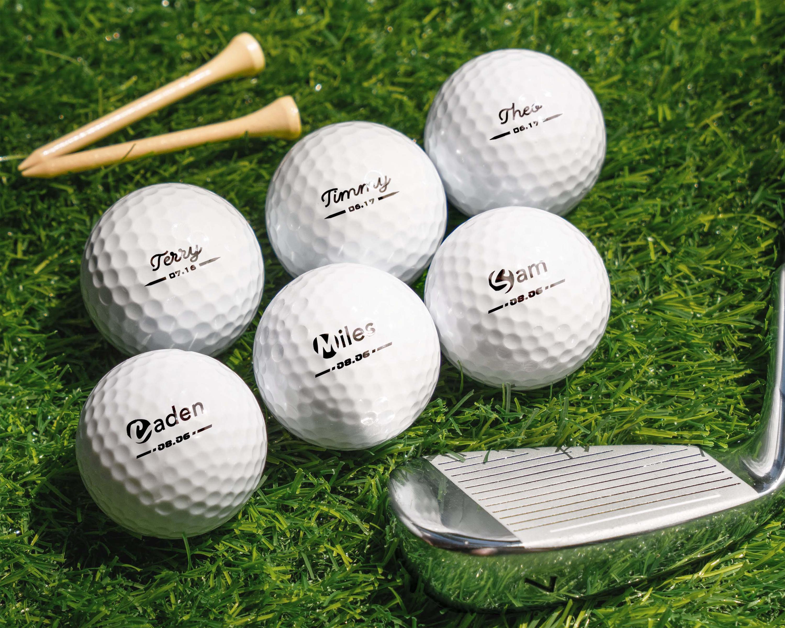 a bunch of golf balls and a club on the grass