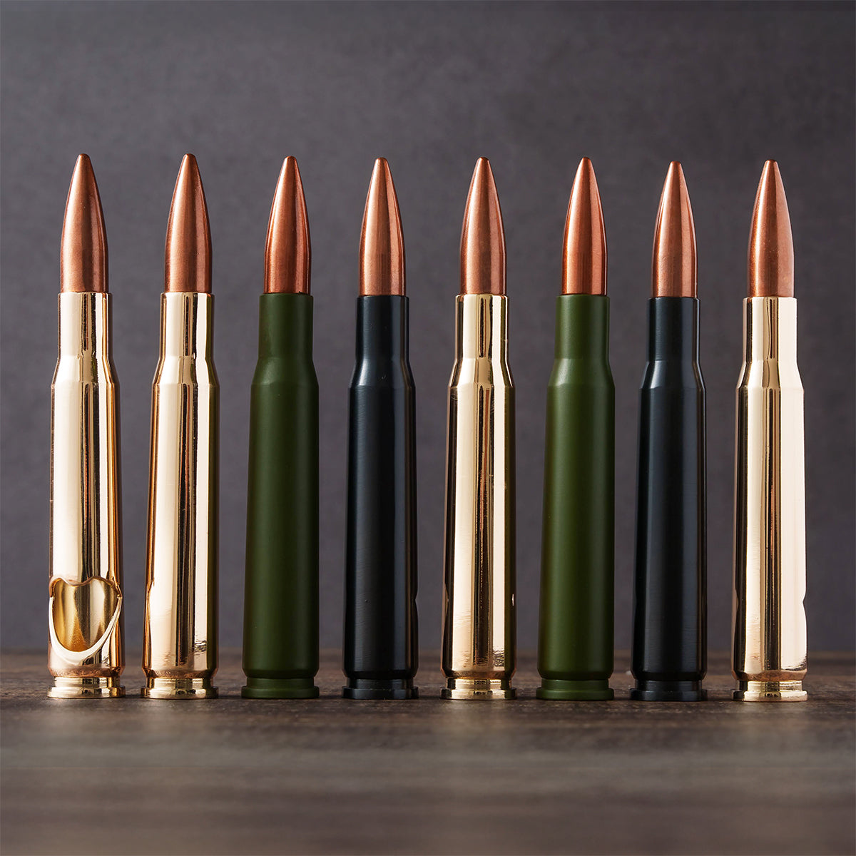Eight bullet bottle openers in gold, green and black lined up