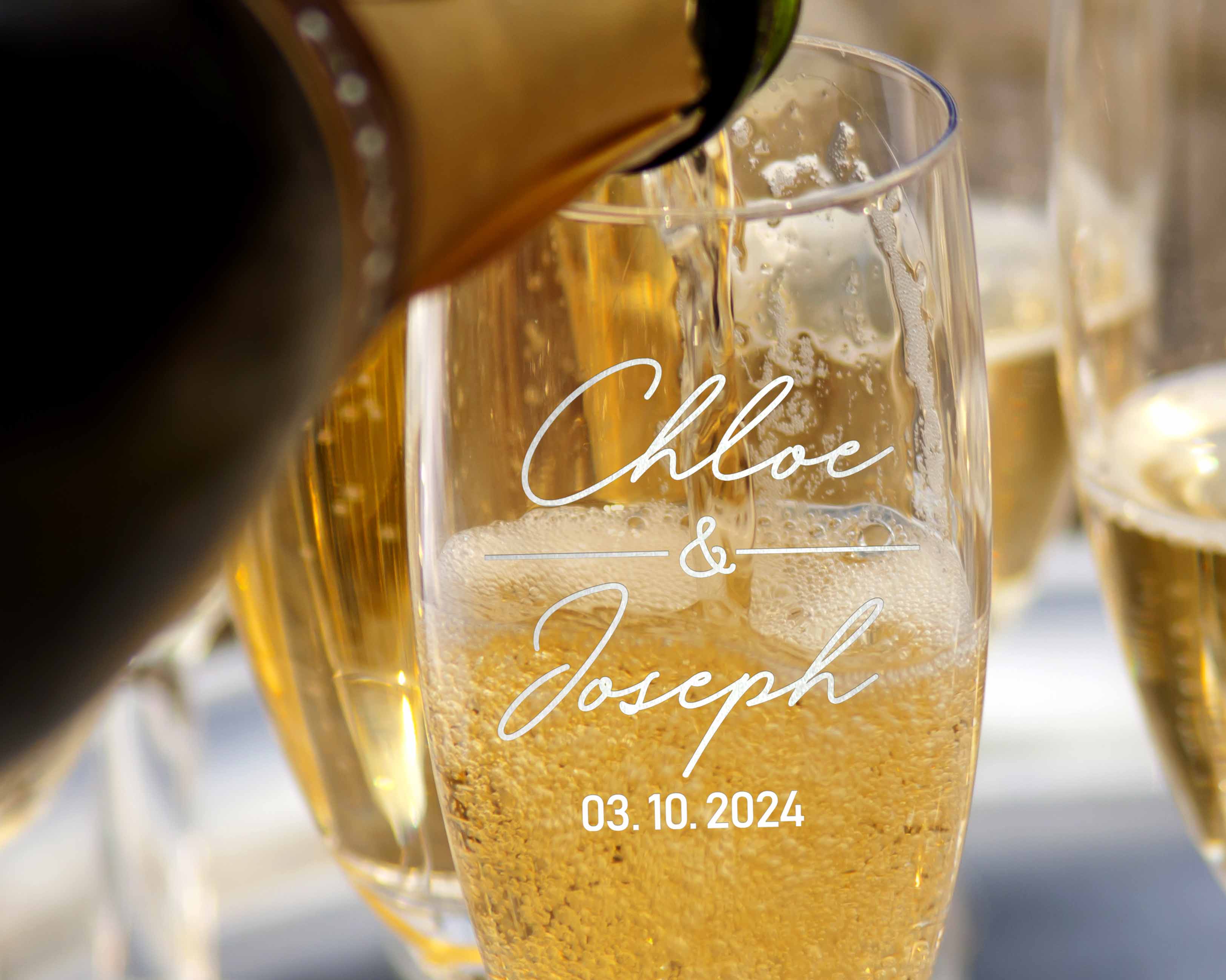 The champagne is poured into custom wedding toasting flutes, which include the names and date on the glasses. These personalized couple wine glasses are perfect for the wedding day for the happy couple.