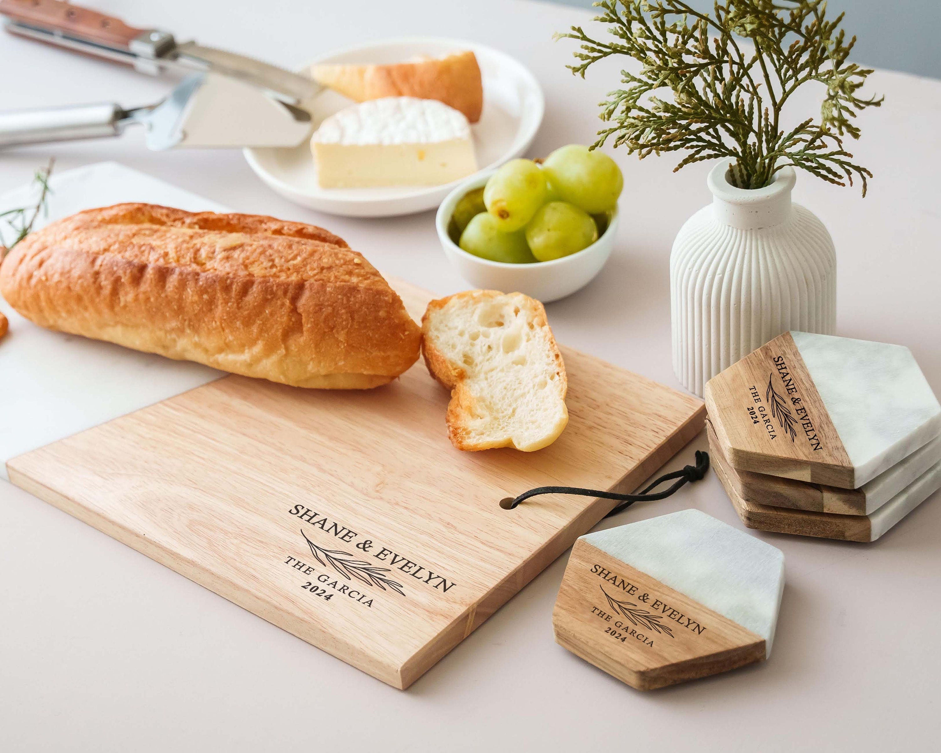 a cutting board with bread, olives, and cheese on it