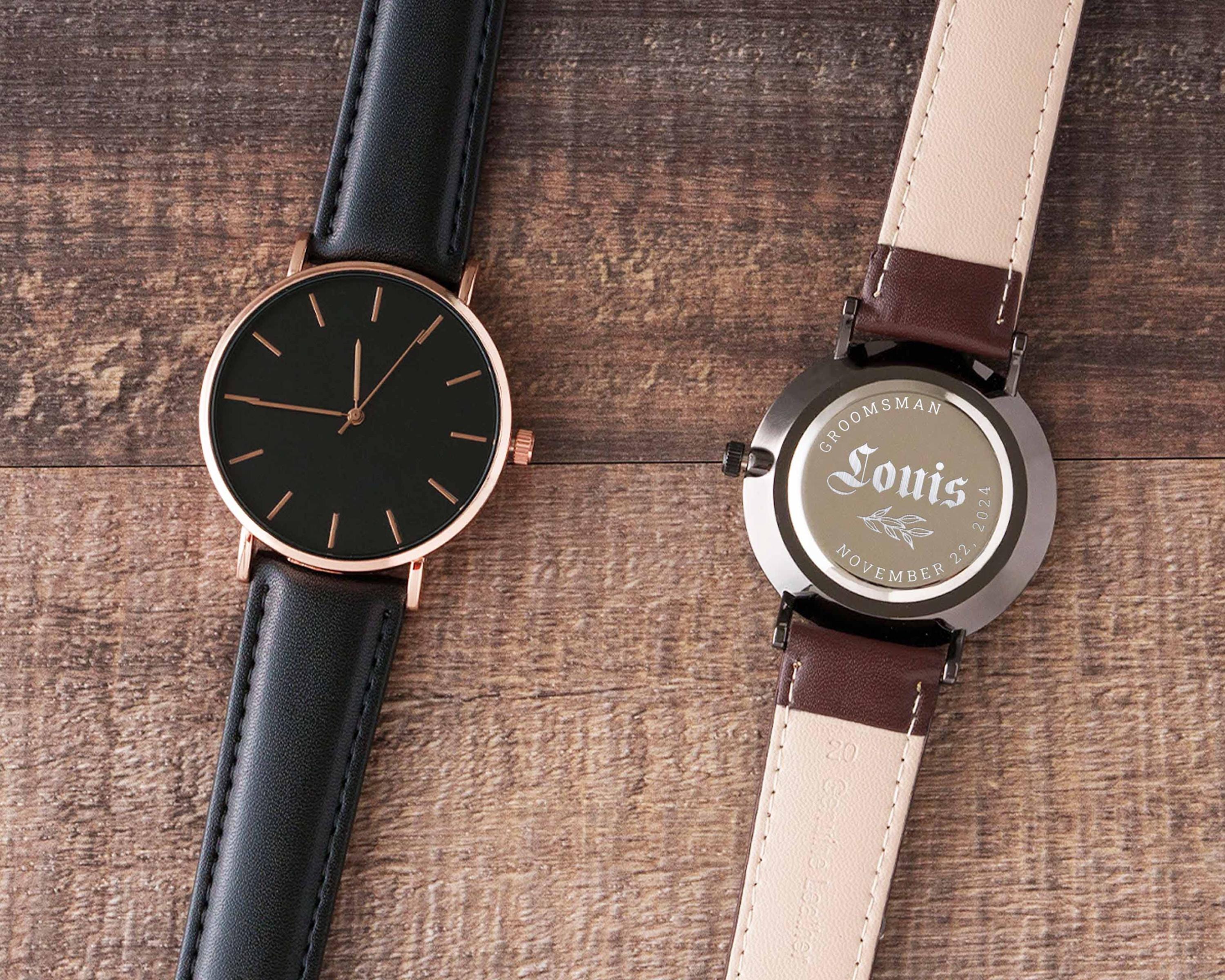 a couple of watches sitting on top of a wooden table