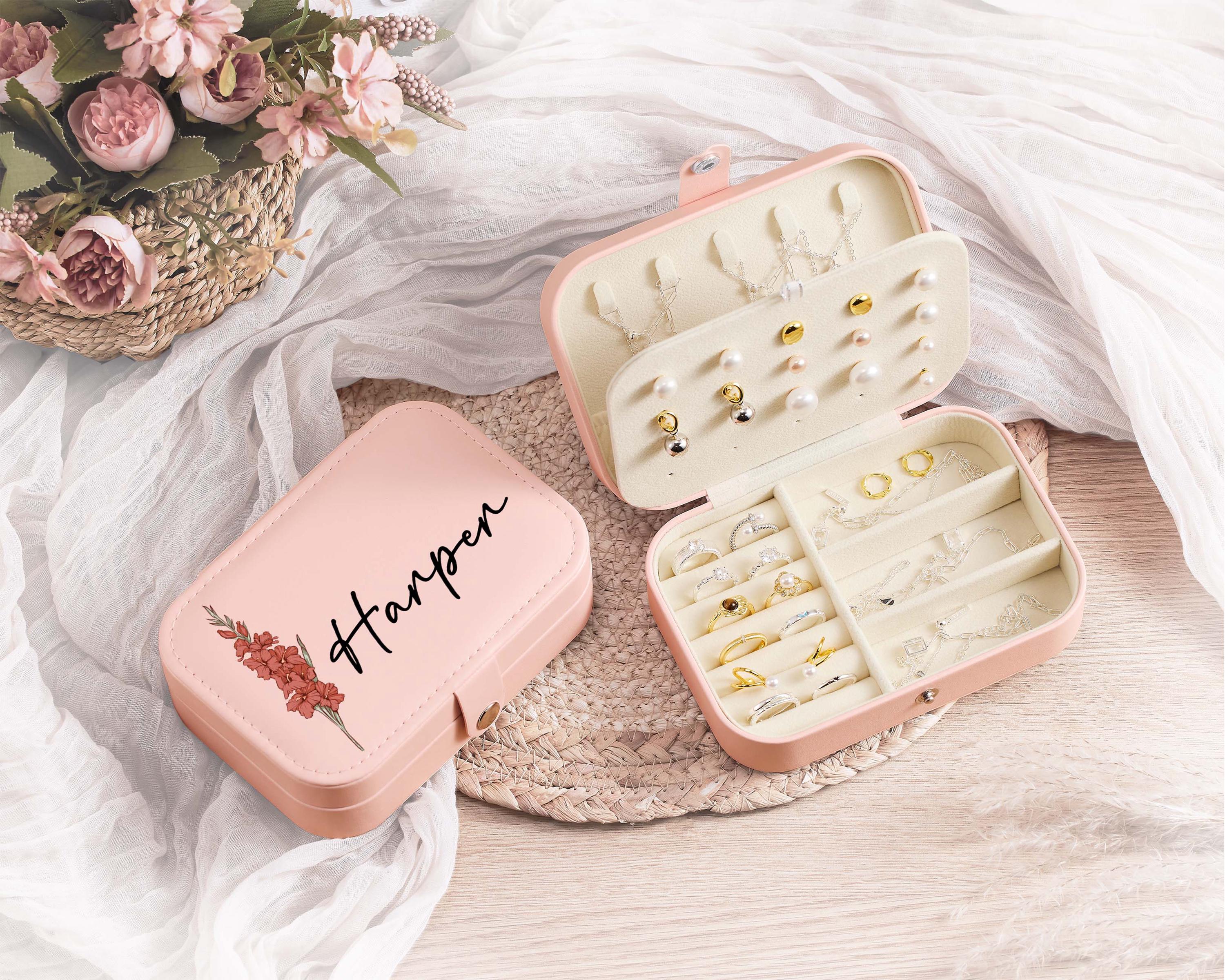 a pair of pink jewelry cases sitting on top of a table