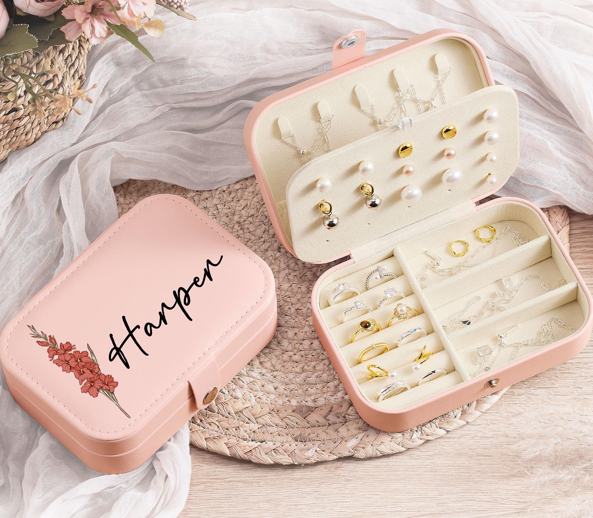 a pair of pink jewelry cases sitting on top of a table