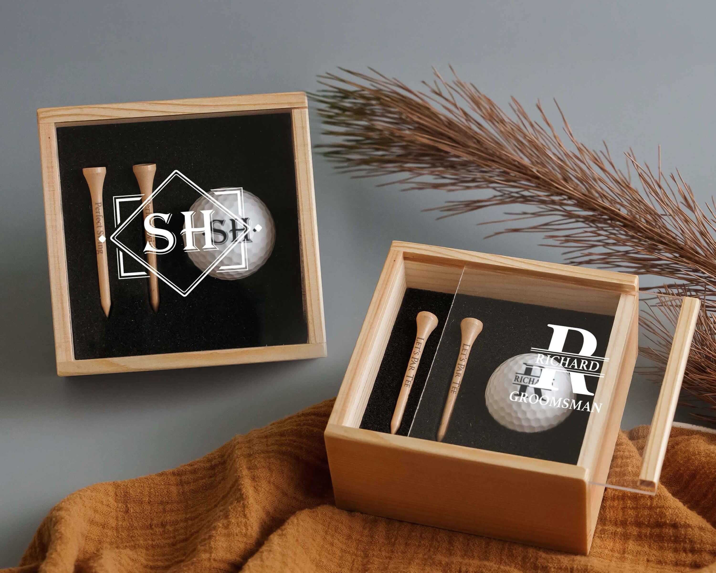 a pair of golf tees in a wooden box