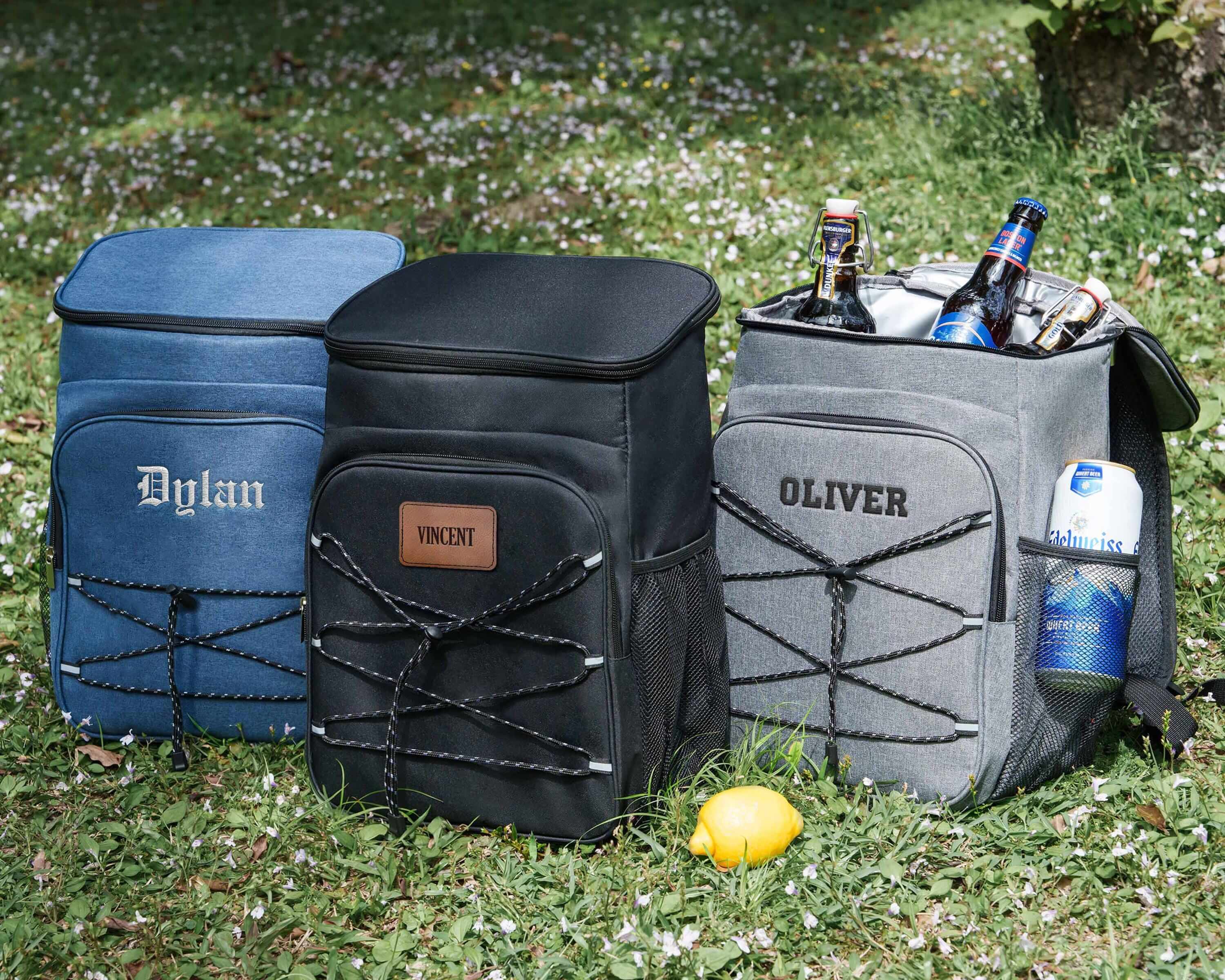 a group of cooler bags sitting on top of a grass covered field