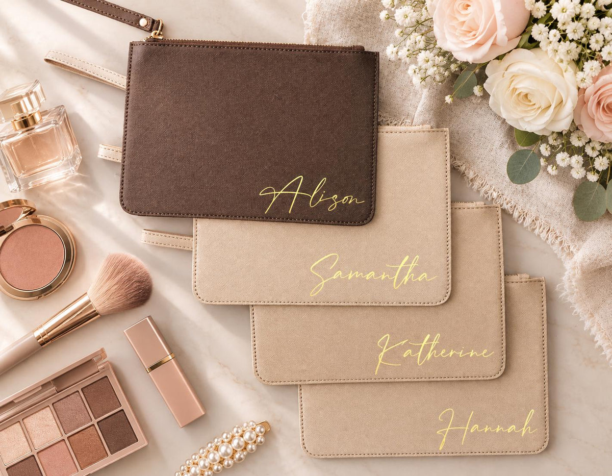 Personalized clutch bags in mocha and oat with gold names for a bridal party