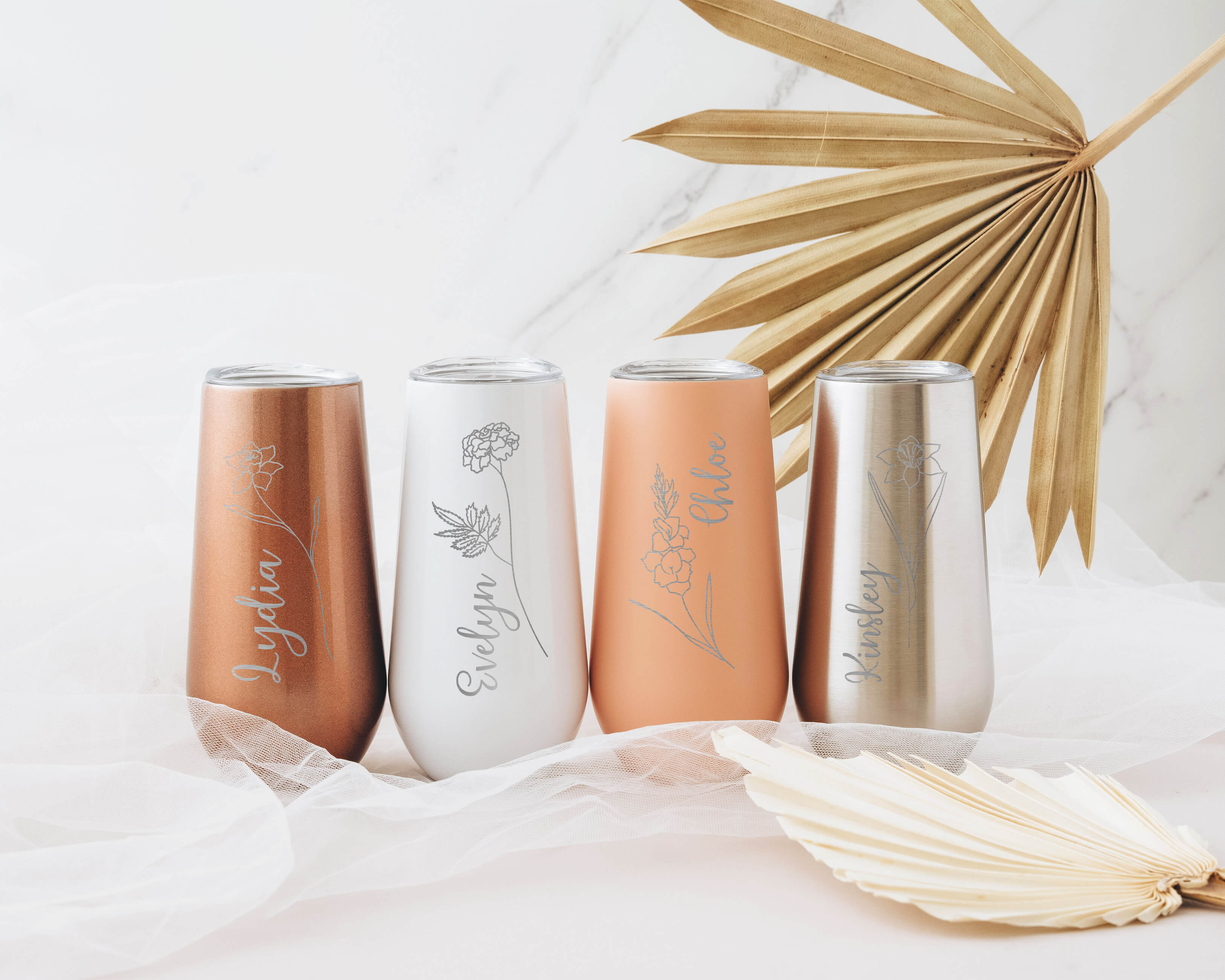 Custom white, rose gold, and pink champagne tumblers with custom birth month flower and name. Custom champagne tumbler is the perfect bridesmaid gifts for your besties.